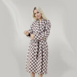 Photo d'une femme blonde portant un peignoir en nid d'abeille ) motif damier marron